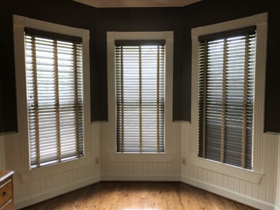 Dark wood blinds give privacy to this space.
