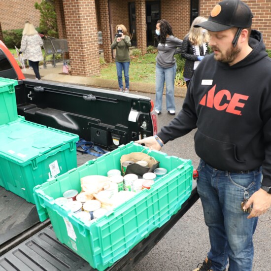 Volunteers unload a truckload of donations at a holiday "stocking" stuffer for the Bellevue Community Food Bank.