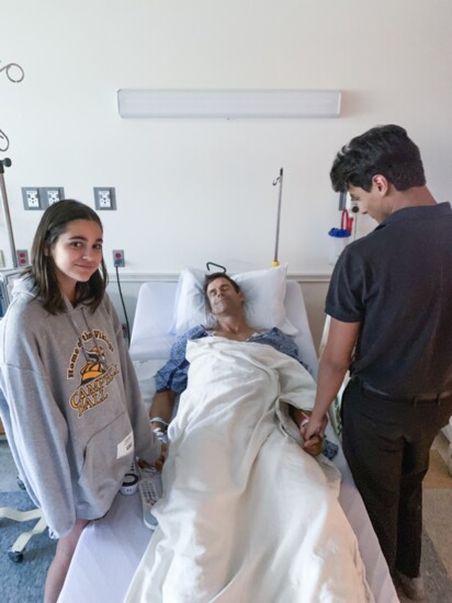 His children join him bedside at the hospital
