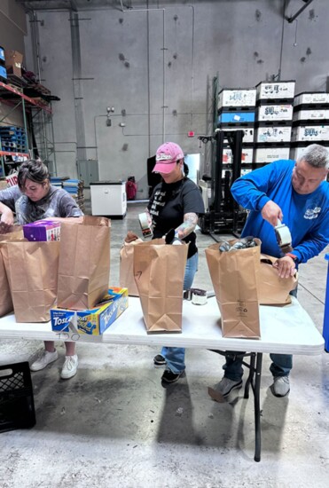 Volunteers carefully curate gift packages for chilren based on age.