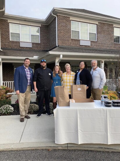 Magnolia Springs staff and sponsors dishing up dinners at the drive-through last year.