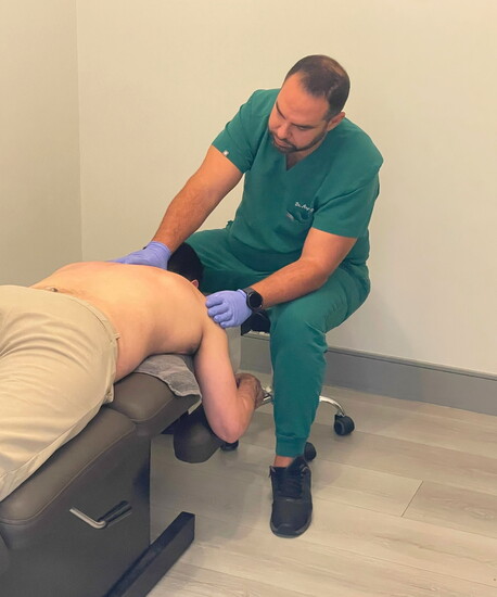 Dr. Diba performs a chiropractic adjustment to help restore proper alignment.