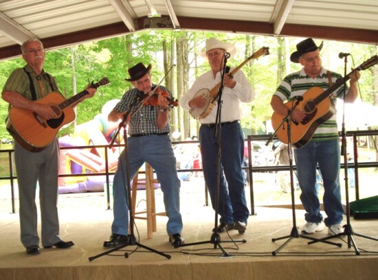Amy's father Jack Sandifer, left, with his Appalachian string band. The book's illustrator, Izzy Bean, included the band in her picture of Dollywood.