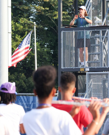 Drum Major Owen Denoziere takes his place on the podium—proudly leading his peers through every count and cue.