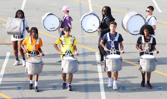 The drumline delivers more than rhythm—it drives the heartbeat of every performance.