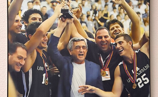 Framed on his office wall: V. Amayakyan (#25, right) with his team and the Armenian prime minister at the 2011 Pan-Armenian Games championship.