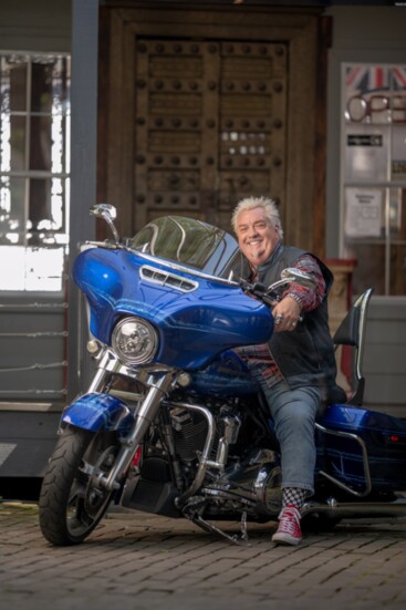 Derrick Spain with his electric blue Harley Davidson