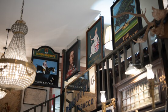 Antique chandeliers, pub signs and vintage decor make for an eclectic atmosphere