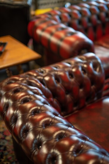 Refurbished Chesterfield sofas in a speakeasy style