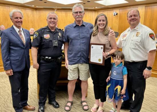 Eden Prairie resident Molly Menton honored for lifesaving actions, with Mayor Ron Case, Police Chief Matt Sackett, Duane Hookom, and Fire Chief Scott Gerber