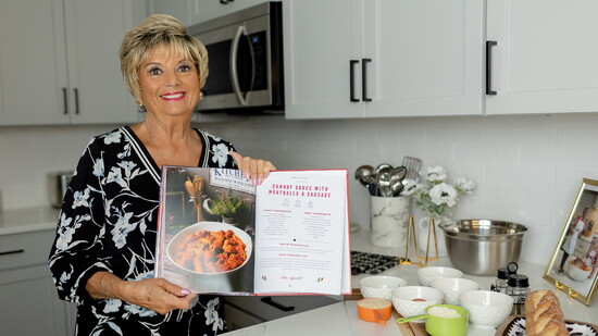Antoinette Gangi with Her Book, Antoinette’s Authentic Italian Cookbook