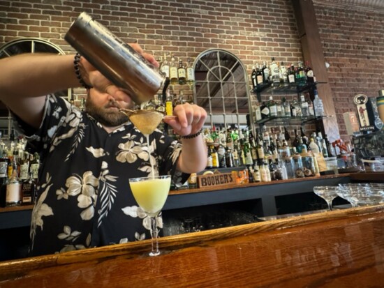 Bartender Dallas J. Sweecy pouring a cocktail