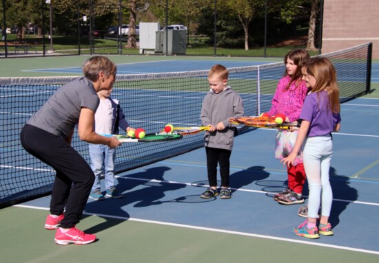 Youth getting their first tennis lesson during Unplug and Be Outside, an annual event featuring a week’s worth of activities in arts, sports and recreation.