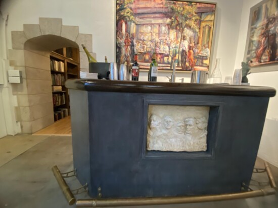 Mort Walker adds Beetle Bailey to Bourglum's Mount Rushmore for the insert sculpture for the bar