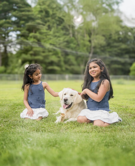 Taara and Vedha with the family dog, Milo