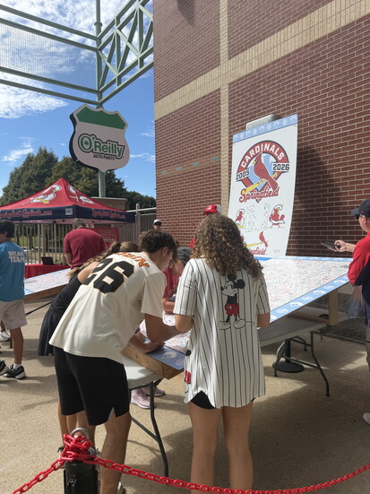 Young fans sign the Cardinals Wall during the final homestand of 2026.
