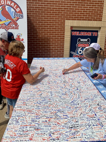 Fans add their names to the commemorative Cardinals Wall.