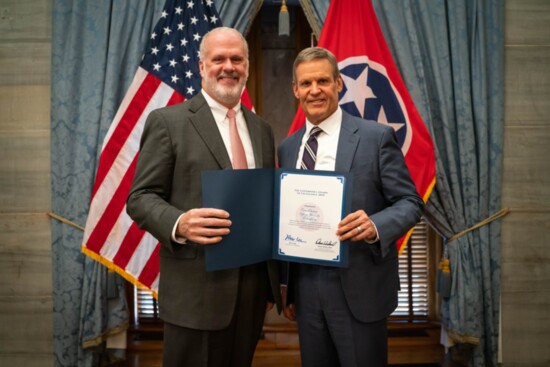 Chris Barnhill (L) receiving the 2021 Governors Award of Excellence on behalf of FrankTown Open Hearts, from Tennessee Governor Bill Lee