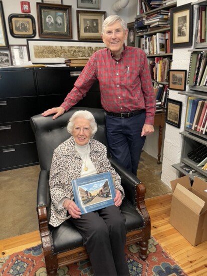 Rick Warwick presenting his latest book, “Four Blocks on Franklin’s Main Street,” to his friend Christine Pigg, who turned 100 years old this year