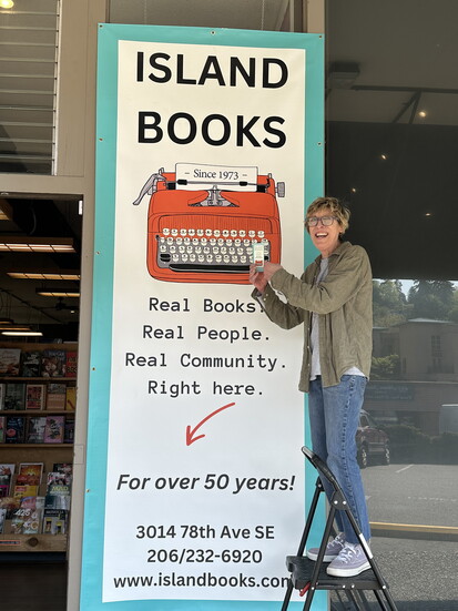 Cindy Corujo and the iconic Island Books sign