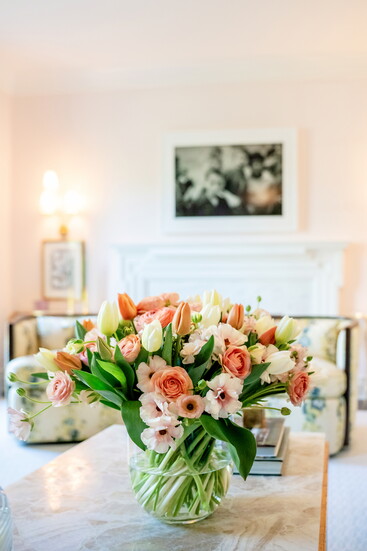 A colorful floral arrangement by City Stems complements the pastel tones of the living room