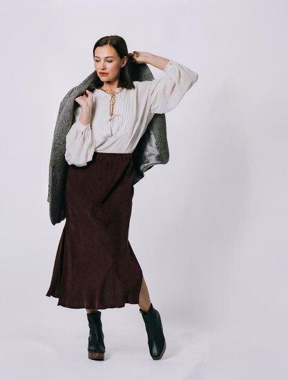 Necklace: Kate Waltman. Coat: Maison Hotel. Skirt: Natalie Busby Bias Slip. Boots: Elianna—Huma Blanco. Shop-loom.com.
