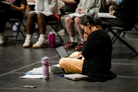 Director Katy Ramsey working with cast on stage