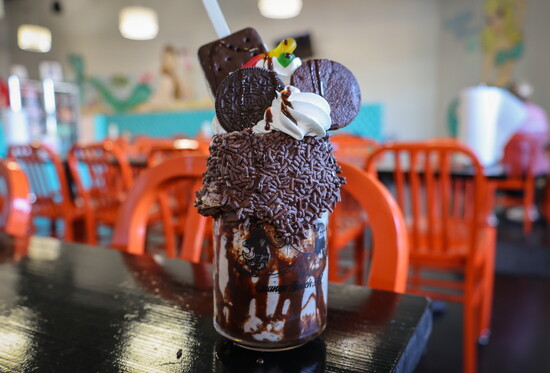 Dirty Cowboy: chocolate sprinkle rim, cookie-n-cream milkshake, Oreo cookies, gummie worms, brownie, ice cream sandwich, & whip.