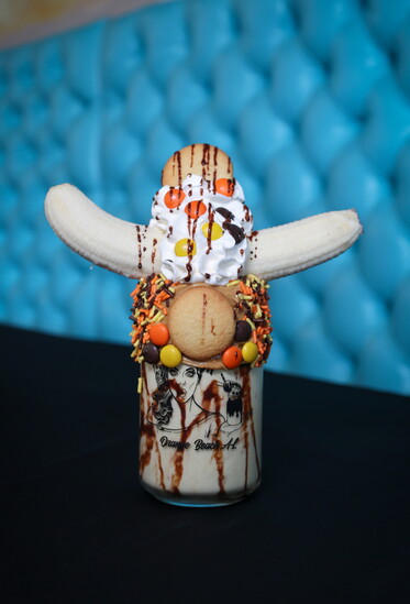 The King: a tribute to Elvis. PB Nilla Wafer rim, chocolate with Nilla wafers, banana pudding milkshake, Reeses’ Pieces, topped with whip & a banana.