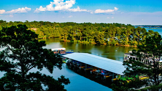 Lake Conroe stretches beyond the resort’s marina, where boating, open water, and East Texas treelines frame the weekend from sunrise to sunset.