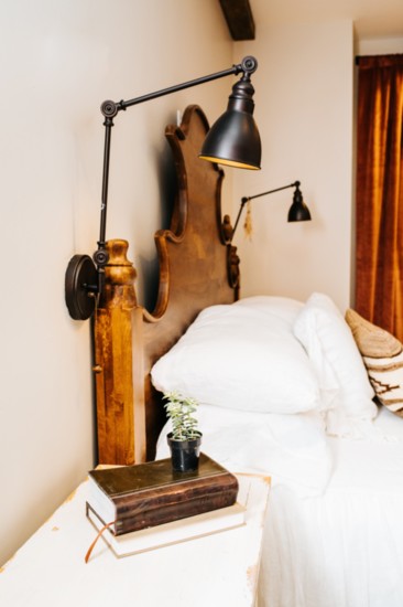Notice the wooden pulls on the reading lamps above the bed