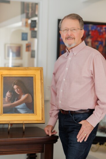 Artist Tom LaRock with one of his portraits