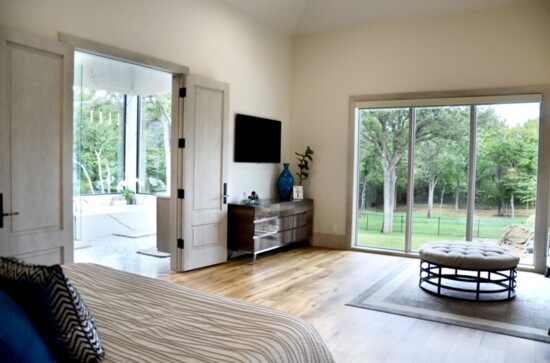 From the master bedroom, you can see the natural light filling the adjacent bathroom coming through the large windows.