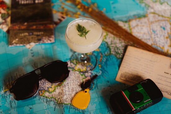 "Scenic Route" cocktail made with gin mare, dried tomato, tzatziki, lemon, and lack pepper.