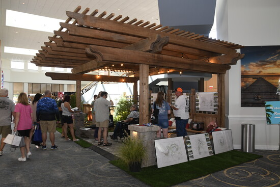 A vendor at the home show selling decks and patio pagodas