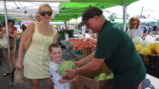 John Specca of Corner-Copia helps young Julian with his weekly haul