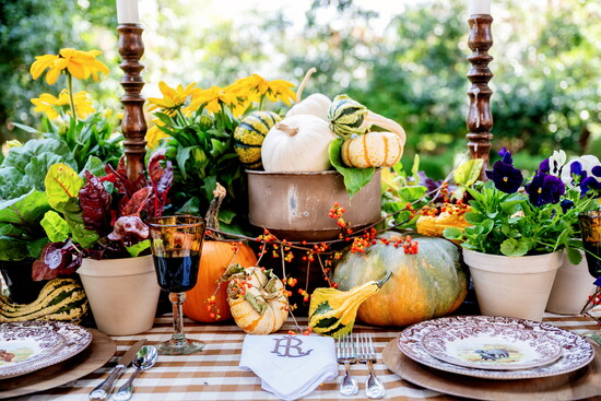Monogrammed linens and incorporating seasonal items like pumpkins add depth to the table