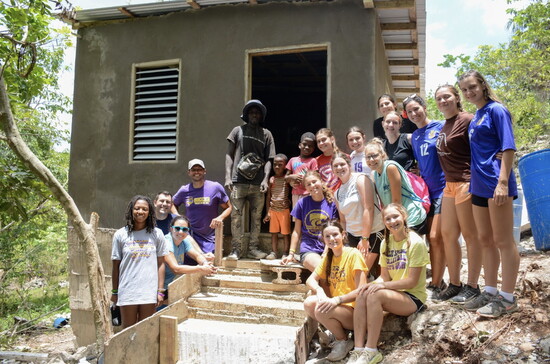 The Won by One team, along with Price and his sons, gathered outside the newly completed home.