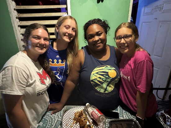 Olivia Crews, Kennedy Smith, and Olivia Peppers with Shani, a Harmons resident, visiting her home to deliver Meals on Wheels.