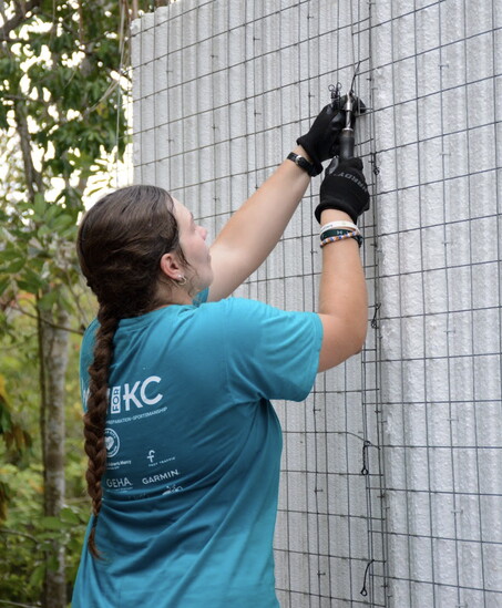 Olivia Crews secures the walls of the home before the concrete is poured.