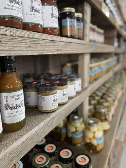Rows of canned goods, including honey, spices, veggies, and more at Theiss Market.
