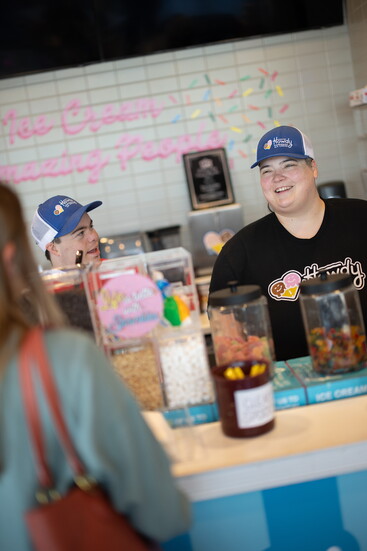 Ben Levine and general manager Kasey Lee serving a customer