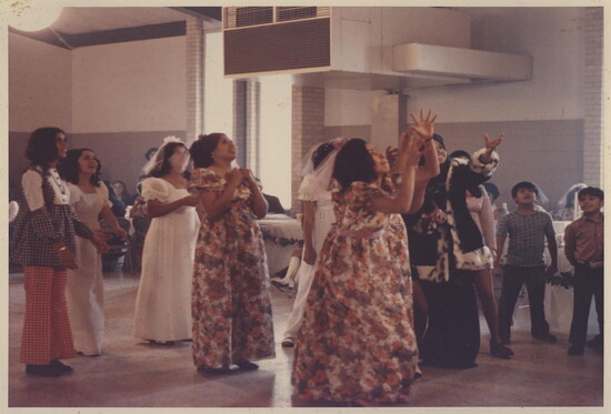 Bouquet toss at a 1970s wedding. 