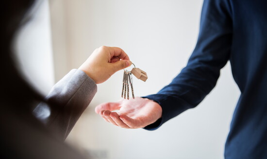 Accepting the keys to a home. 