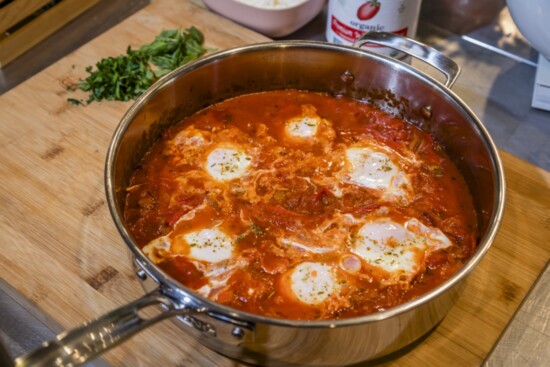 Eggs poach in the flavorful red sauce in Chef Leah Di Bernardo's Mediterranean inspired Shakshuka recipe.  Perfect for Mother's Day.