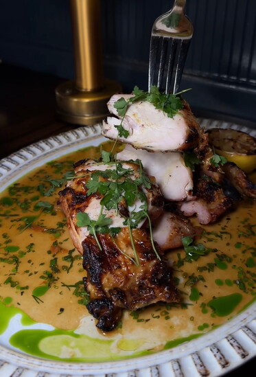 Bouboulina's hearth grilled chicken with jus, roasted garlic, thyme, and grilled lemon
