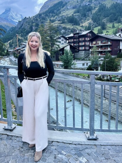 Kellie Walton in Zermatt, Switzerland with the view of The Matterhorn (upper left) that inspired the famous logo of Toblerone chocolate.