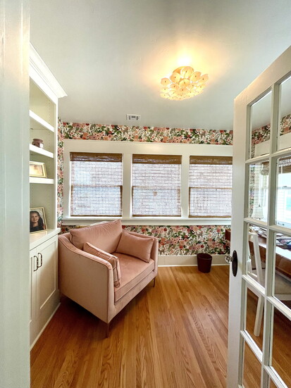Built-ins are back! This second-floor study reflects the owner’s personality with floral wallpaper and a delicate glass ceiling fixture.