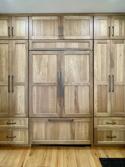 This cognac-stained hickory refrigerator/pantry wall brings warmth to a Mesta Park kitchen.