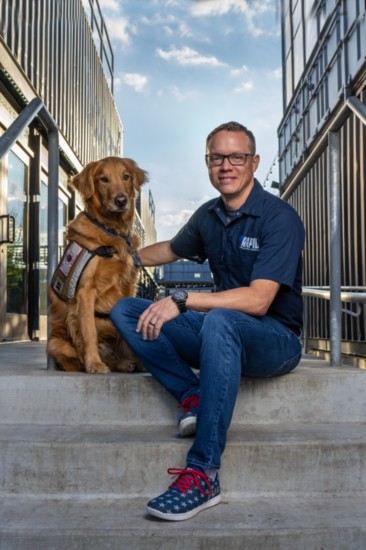 Terry Hill, shown with service dog Jonsey, is the CEO and co-founder of Rapid Application Group 